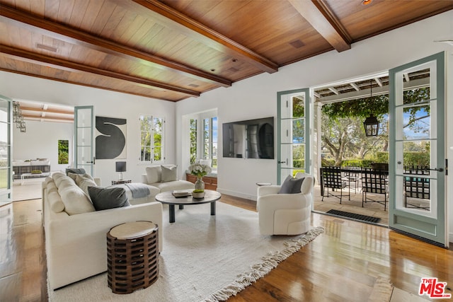 living room with wood ceiling, beamed ceiling, and light wood-type flooring