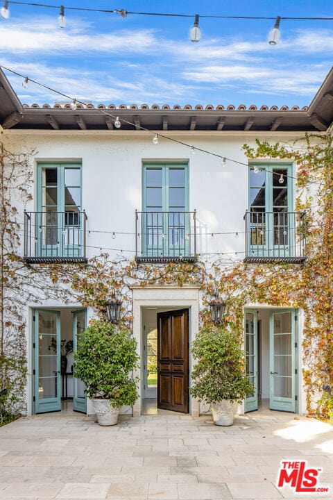 view of front facade with a balcony and a patio area