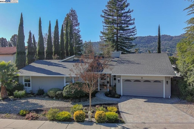 view of property with a garage and a mountain view