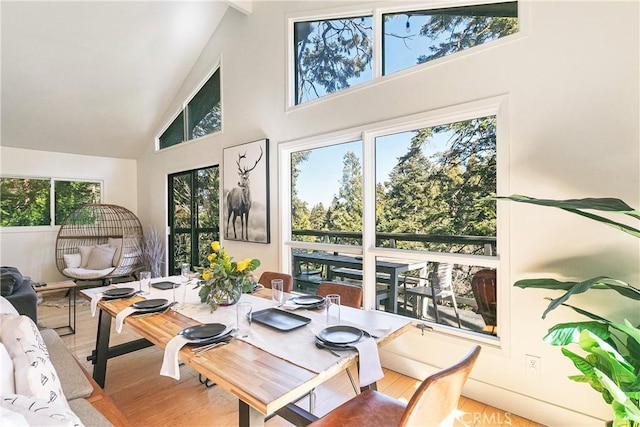 sunroom / solarium featuring vaulted ceiling