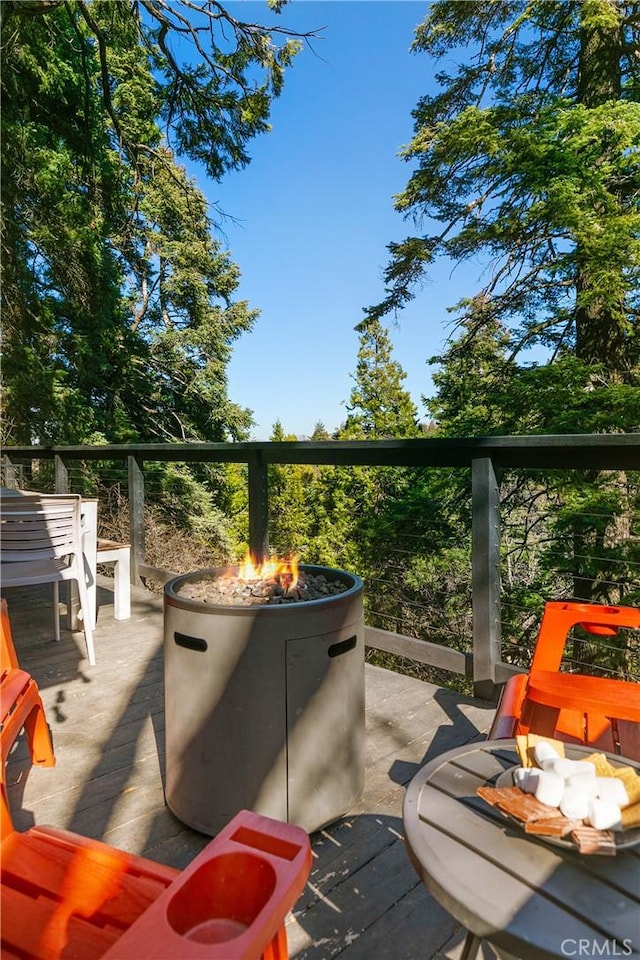 view of patio featuring a deck and a fire pit