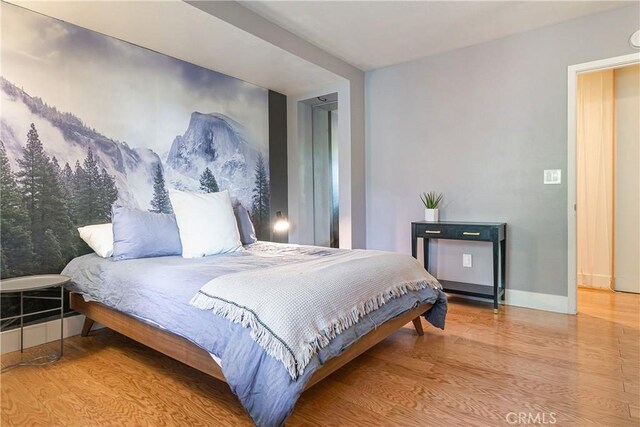 bedroom with wood-type flooring