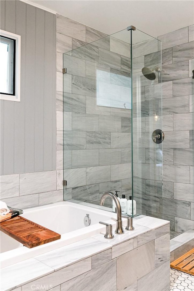 bathroom featuring shower with separate bathtub