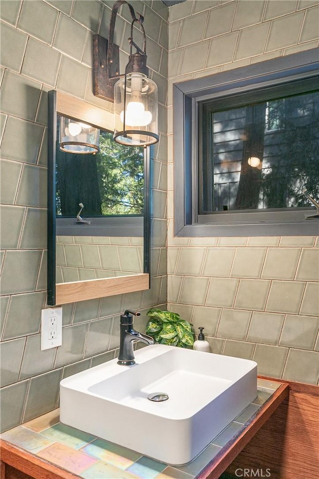 bathroom with sink, tile walls, and backsplash