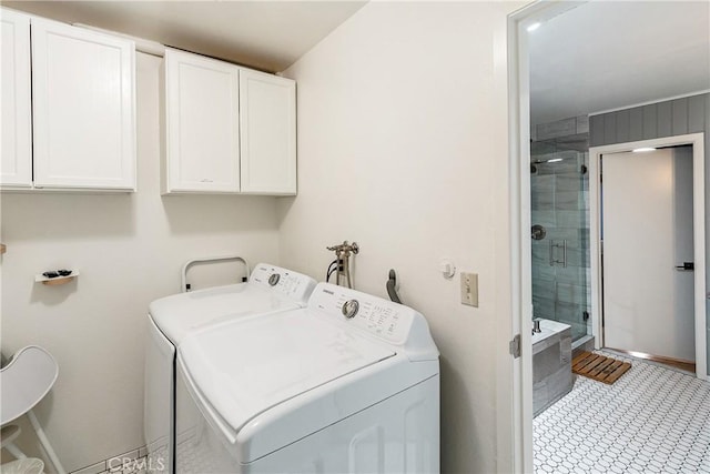 laundry area featuring independent washer and dryer and cabinets