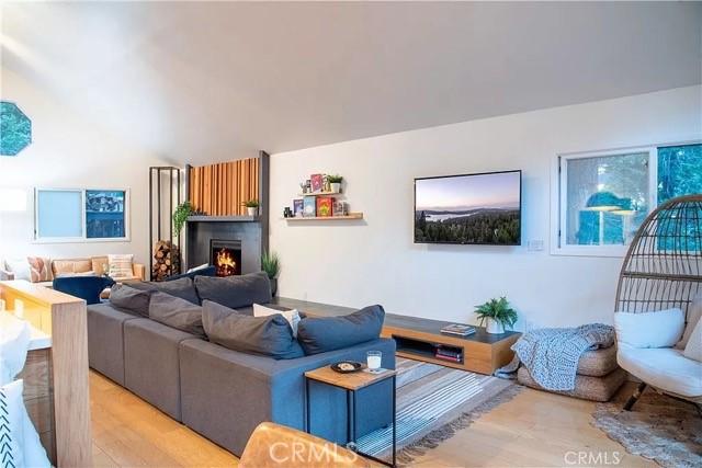 555 Dover Ct, Lake Arrowhead, CA 92352 - living area featuring a lit fireplace and light wood-type flooring