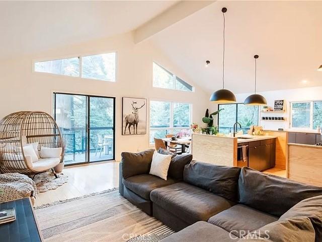 555 Dover Ct, Lake Arrowhead, CA 92352 - living area featuring high vaulted ceiling, beamed ceiling, and light wood finished floors
