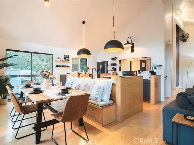 555 Dover Ct, Lake Arrowhead, CA 92352 - dining area featuring light wood-style flooring and a high ceiling