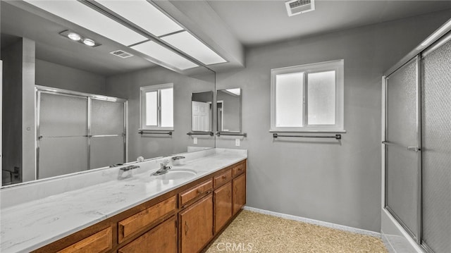 bathroom with enclosed tub / shower combo and vanity