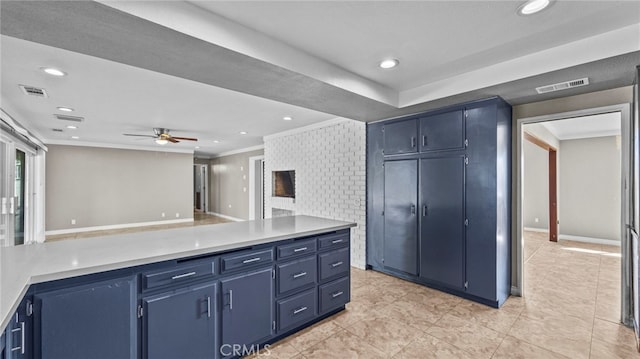 kitchen featuring ceiling fan, ornamental molding, blue cabinets, and light tile patterned floors