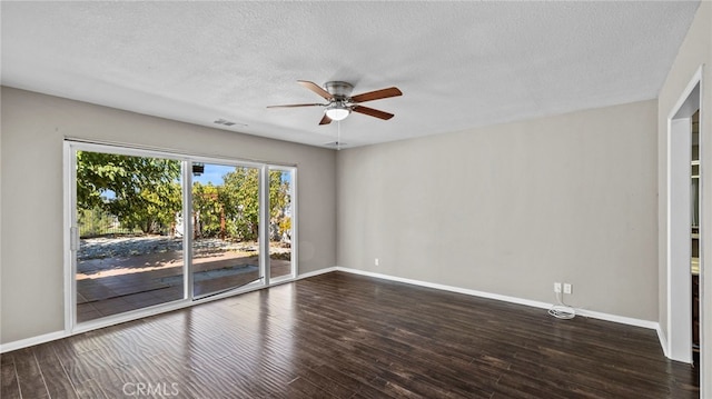 spare room featuring dark hardwood / wood-style flooring, a textured ceiling, and ceiling fan