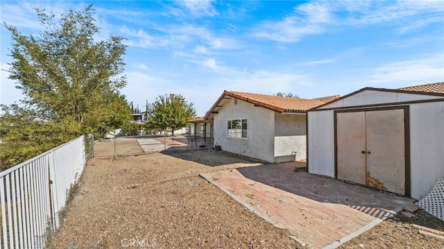 view of property exterior featuring a storage unit