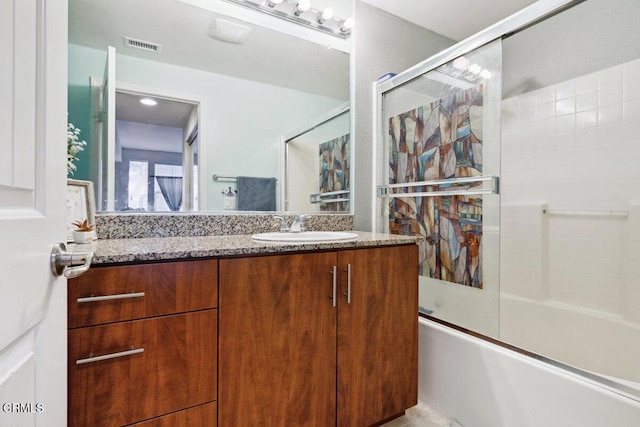 bathroom with vanity and shower / bath combination with glass door