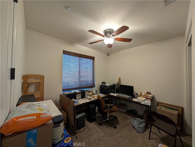 office space with ceiling fan, carpet floors, and a textured ceiling