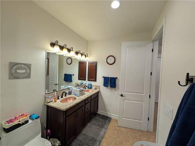 bathroom featuring tile patterned flooring, vanity, and toilet