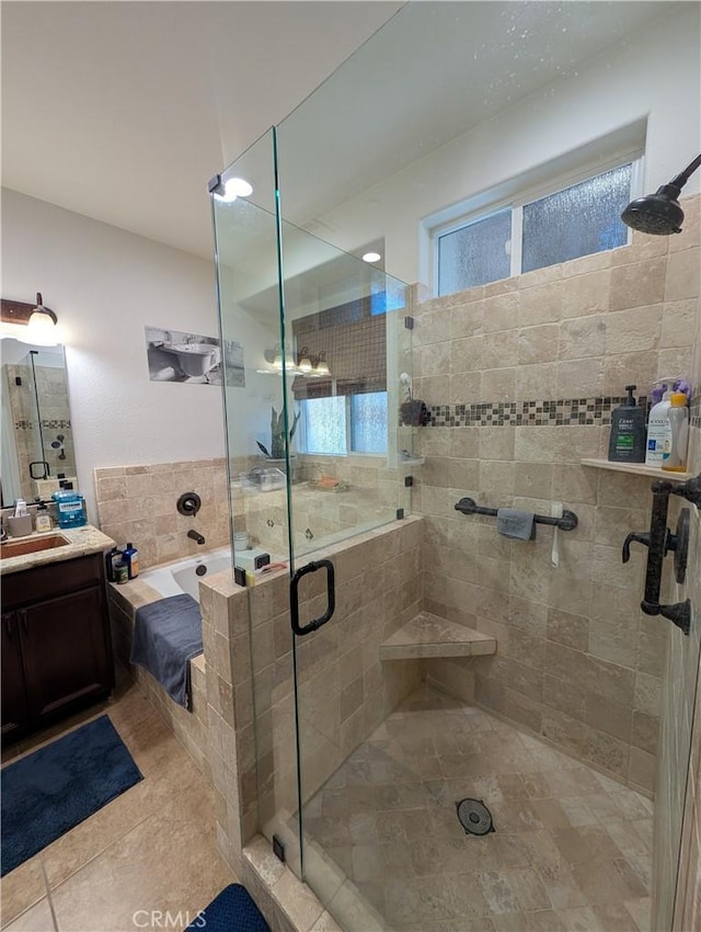 bathroom with tile patterned floors, vanity, and independent shower and bath