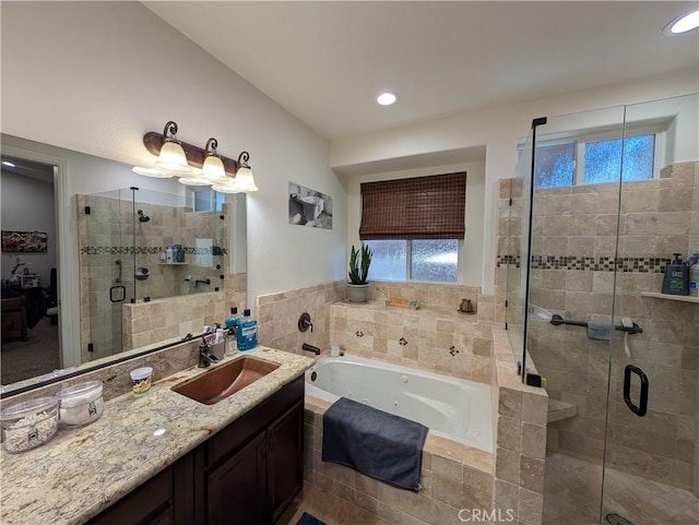 bathroom featuring vanity and independent shower and bath