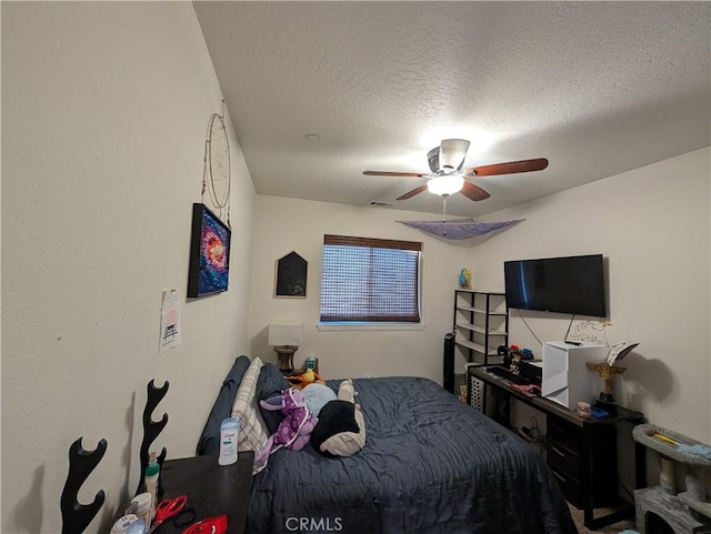 bedroom with a textured ceiling and ceiling fan