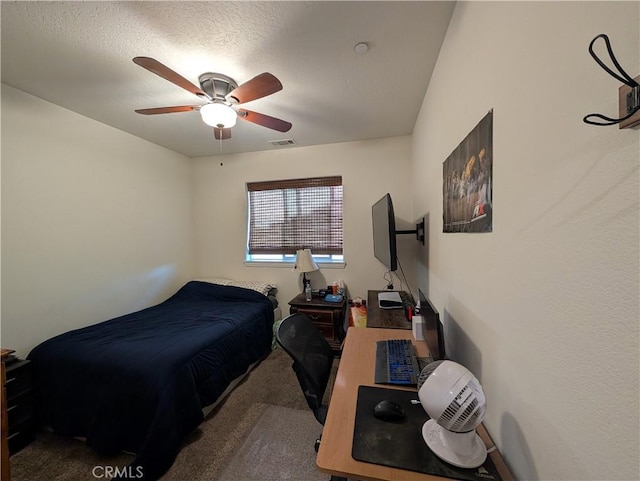 carpeted bedroom featuring a textured ceiling and ceiling fan