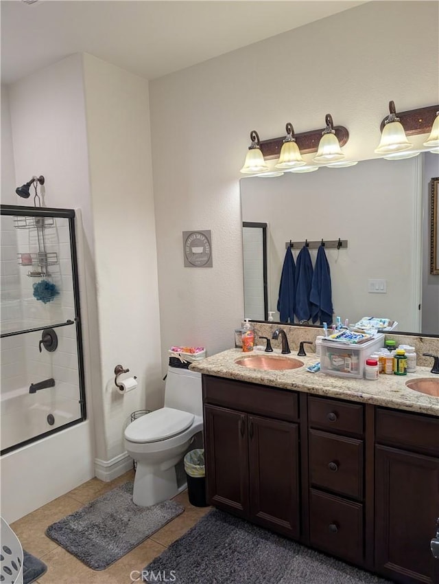 full bathroom featuring tile patterned flooring, vanity, shower / bath combination with glass door, and toilet