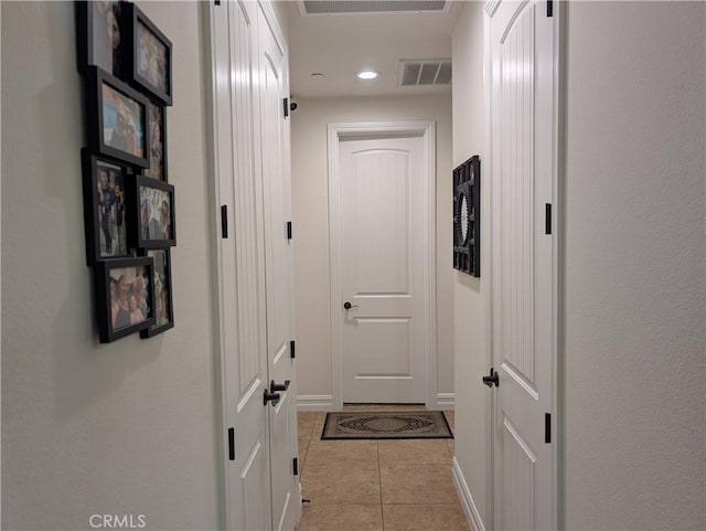 hall featuring light tile patterned flooring