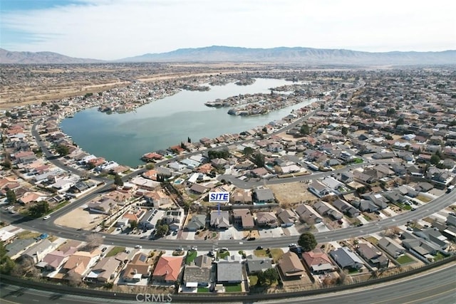 drone / aerial view featuring a water and mountain view