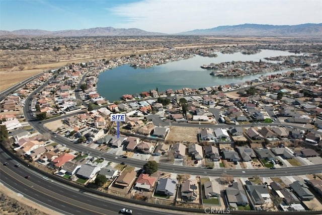 birds eye view of property with a water and mountain view