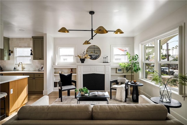 living room with sink and light wood-type flooring