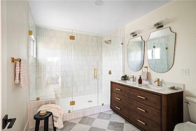 bathroom featuring vanity, an enclosed shower, and toilet