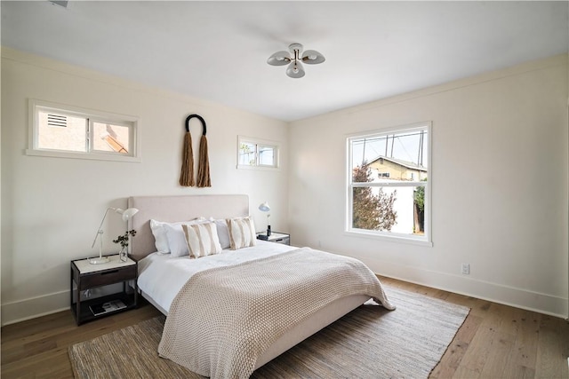 bedroom with dark hardwood / wood-style floors