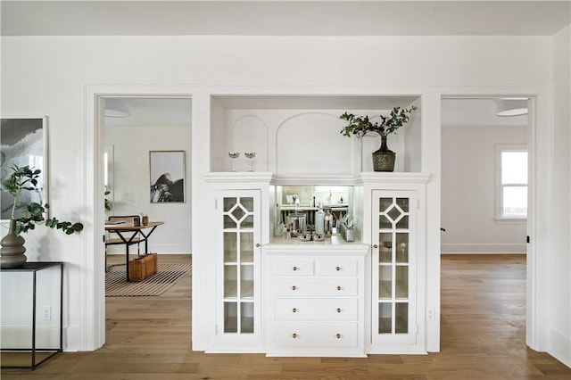 bar with hardwood / wood-style flooring