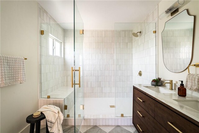 bathroom featuring vanity and an enclosed shower