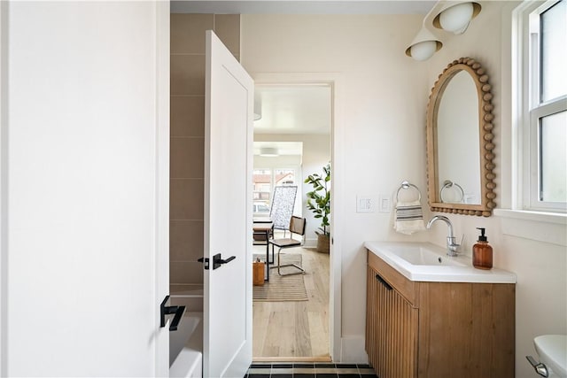 bathroom featuring plenty of natural light, toilet, and vanity