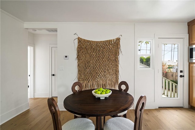 dining space with light hardwood / wood-style floors