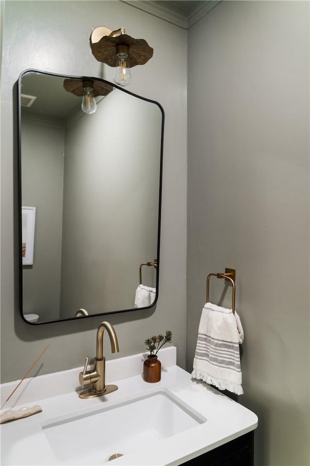 bathroom featuring vanity and crown molding