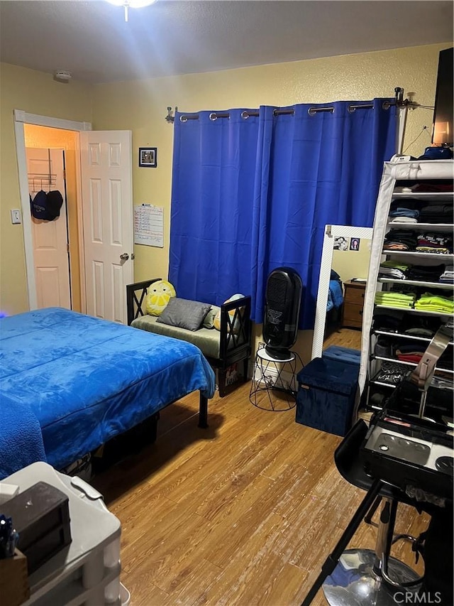 bedroom with wood-type flooring