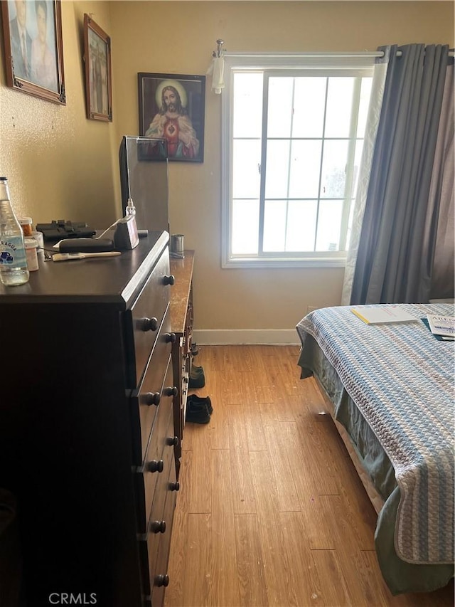 bedroom with light wood-type flooring