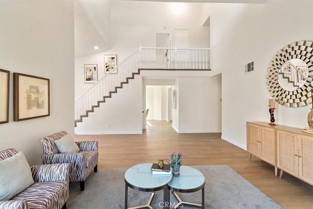 living room featuring hardwood / wood-style flooring and a high ceiling