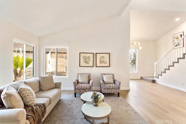 living room with lofted ceiling and light hardwood / wood-style flooring