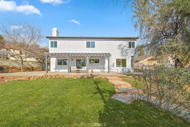 rear view of house with a yard, a pergola, and a patio