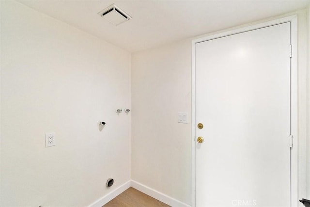 washroom featuring hookup for a washing machine and light hardwood / wood-style floors