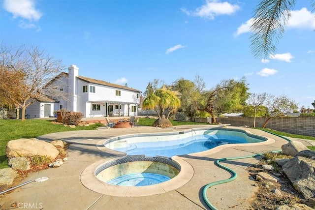 view of swimming pool with an in ground hot tub and a patio area