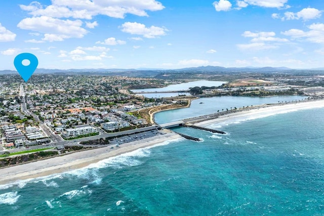 drone / aerial view featuring a water view and a view of the beach