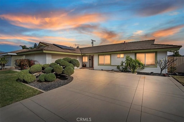 ranch-style house with solar panels