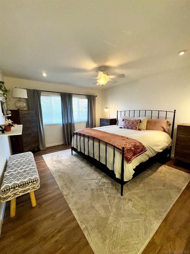 bedroom featuring ceiling fan and dark hardwood / wood-style flooring