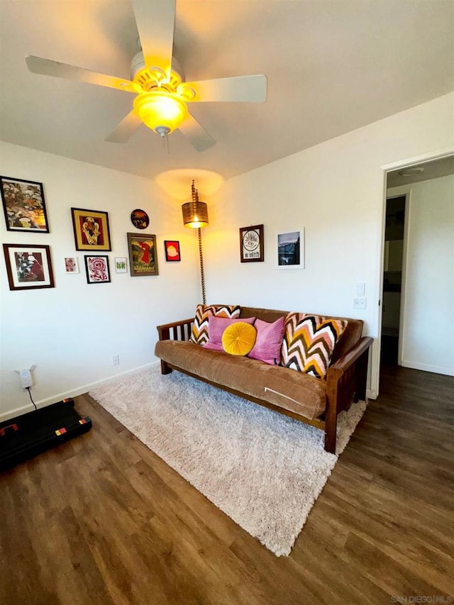 living room with ceiling fan and dark hardwood / wood-style floors