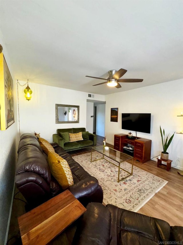 living room featuring hardwood / wood-style flooring and ceiling fan