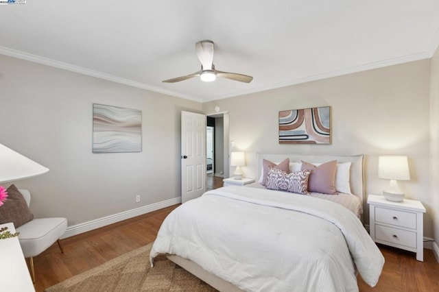 bedroom with crown molding, hardwood / wood-style flooring, and ceiling fan