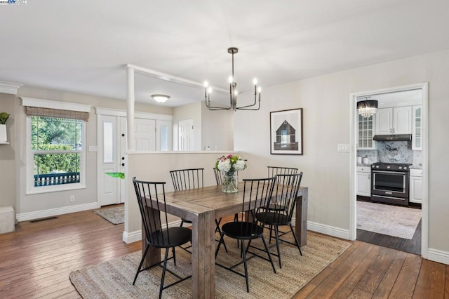 dining room featuring dark hardwood / wood-style floors and a chandelier