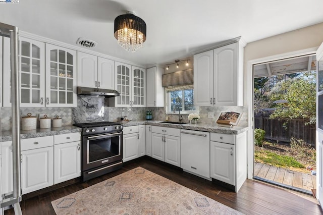 kitchen featuring sink, dishwasher, white cabinetry, gas stove, and decorative backsplash